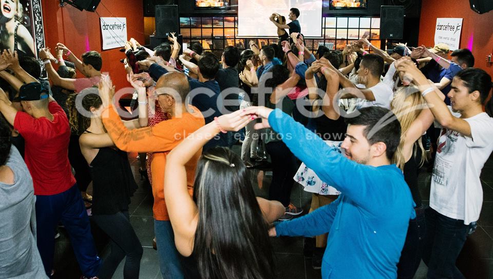 A group of people dancing in front of a crowd.