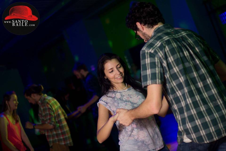 A man and woman dancing in the dark.