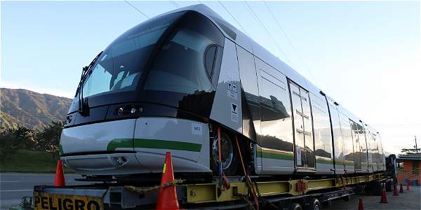 A train car is being loaded on the tracks.