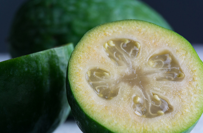 A close up of the inside of a green fruit