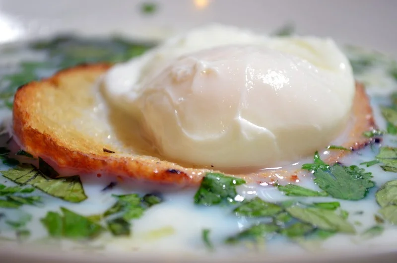 A close up of an egg on top of bread