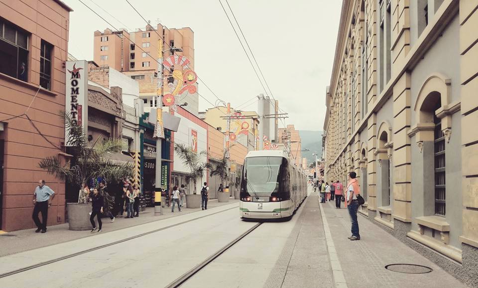 A tram is going down the street in a city.