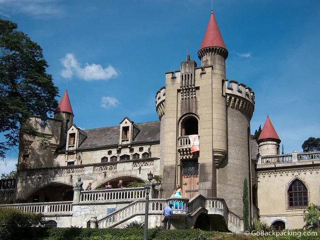 A castle like building with red roof and turrets.