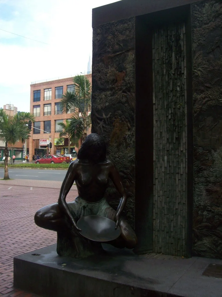 A statue of a woman sitting on the ground