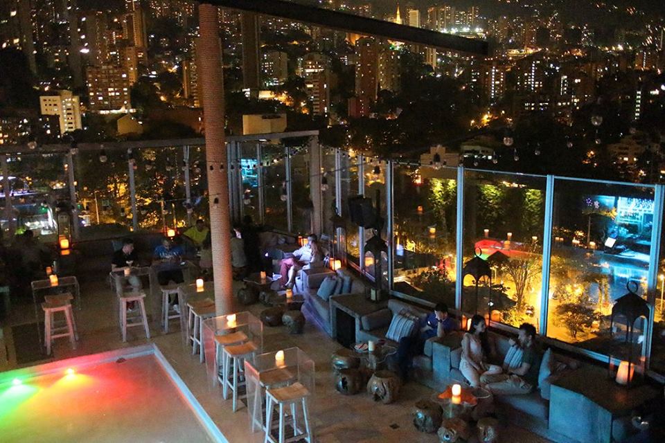 A group of people sitting on the side of a building.