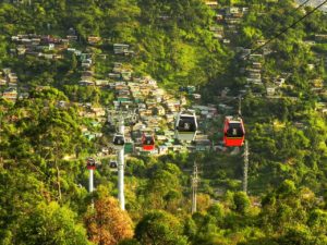 A view of the city from above with two gondolas.